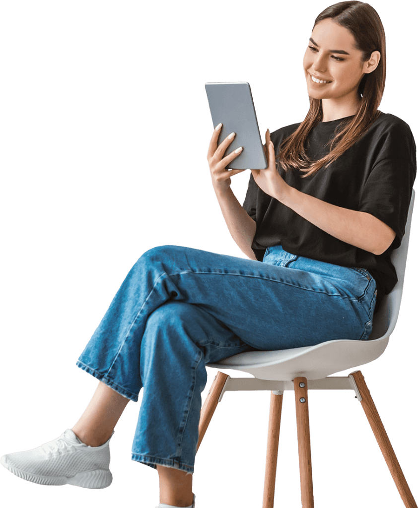 A woman sitting in a chair and using a tablet.